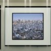 Aerial view of a densely packed urban cityscape with numerous buildings under a clear sky, over Tokyo.